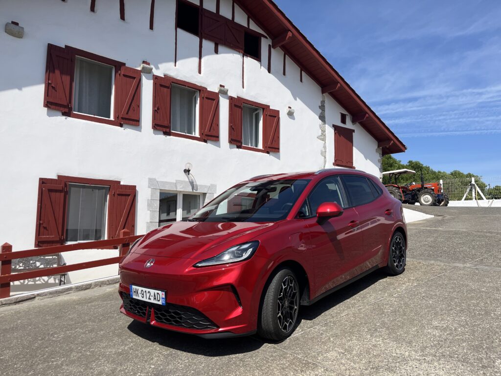 La nouvelle MG4 EV Urban photographiée devant une maison basque typique